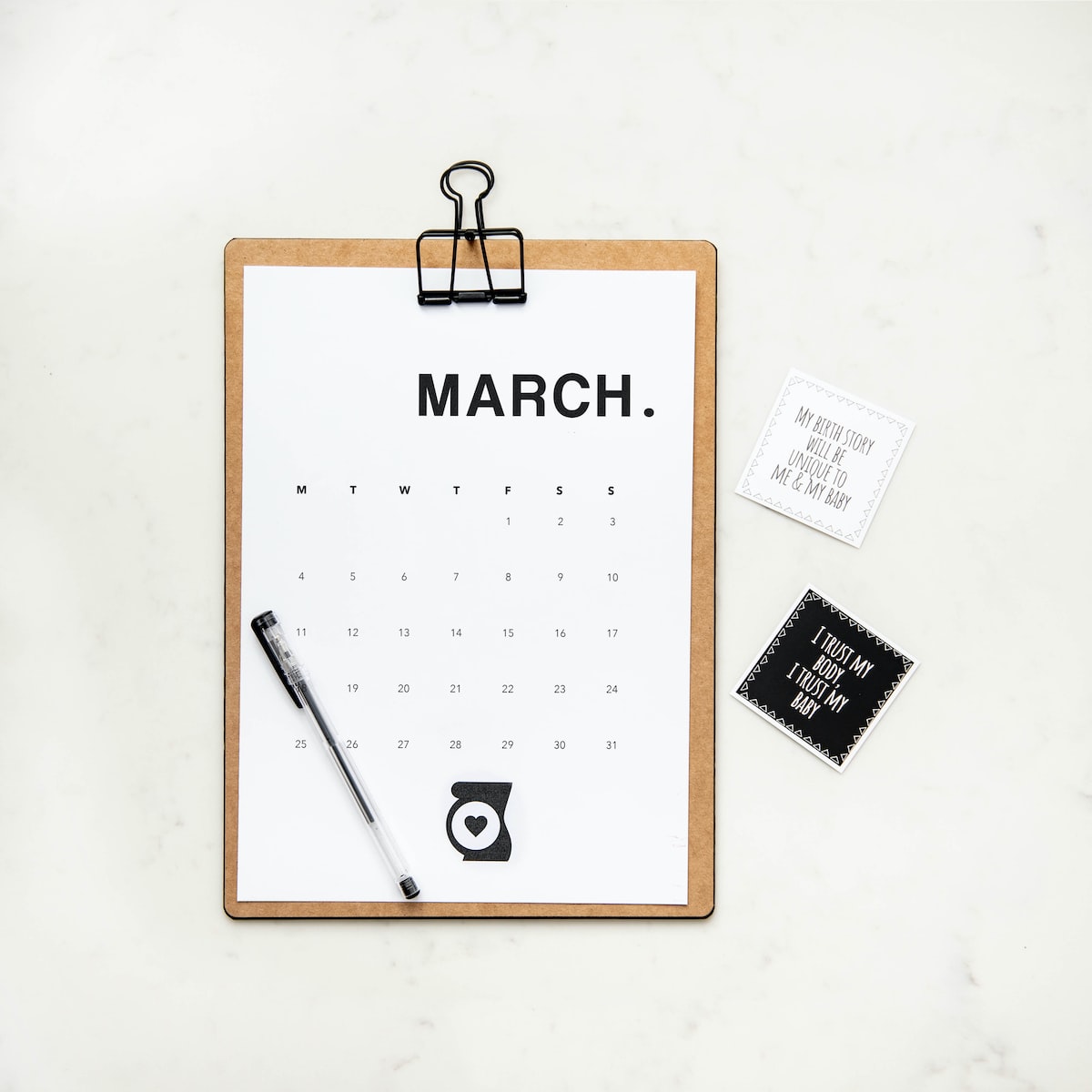 minimalist photography of a calendar with writing pen